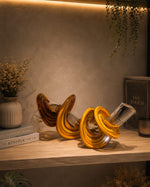 Load image into Gallery viewer, Amber Glass Knot Sculpture Set of 2 – Modern Artistic Glass Table Décor | Luxury Handcrafted Decorative Showpieces